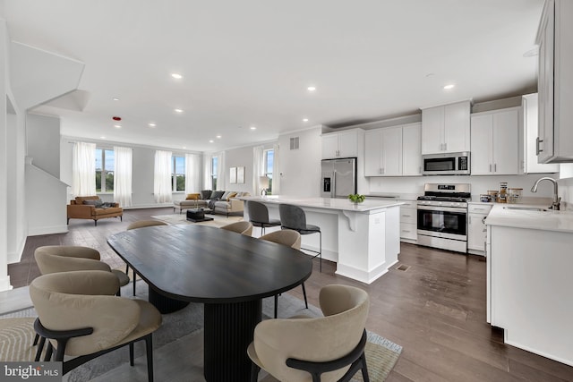dining area with dark wood-type flooring, visible vents, baseboards, and recessed lighting