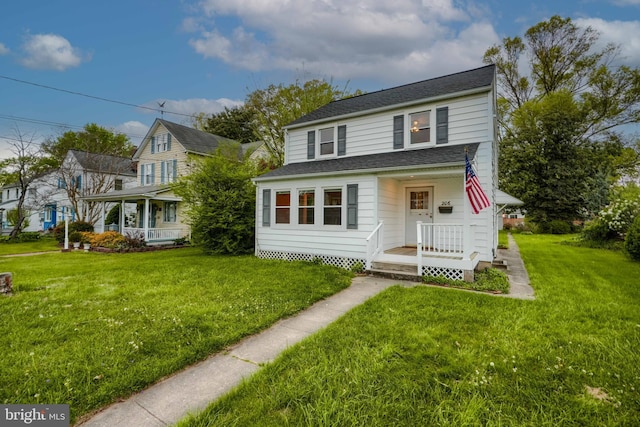 view of front facade featuring a shingled roof, a porch, and a front yard