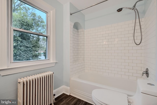 full bath featuring shower / tub combination, wood finished floors, baseboards, toilet, and radiator