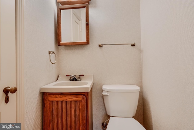 half bath with vanity and toilet