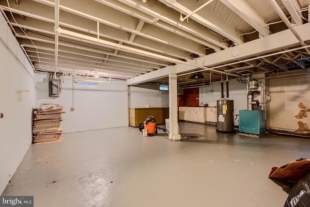 unfinished basement with water heater and a heating unit