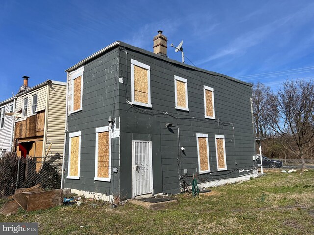2109 Fairlawn Ave SE, Washington, DC 20020 - back of house featuring a lawn, fence, and a chimney