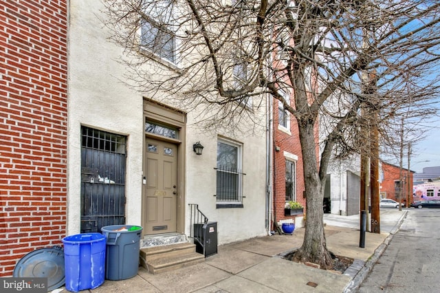 1240 Leopard St, Philadelphia, PA 19125 - doorway to property with stucco siding and brick siding