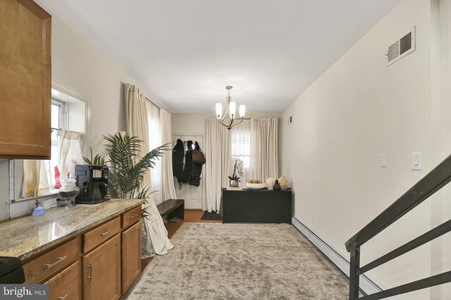 1240 Leopard St, Philadelphia, PA 19125 - interior space with brown cabinetry, a chandelier, visible vents, and a healthy amount of sunlight