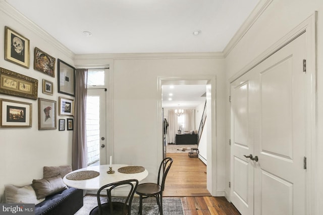 1240 Leopard St, Philadelphia, PA 19125 - dining space with crown molding, a notable chandelier, dark wood finished floors, and plenty of natural light