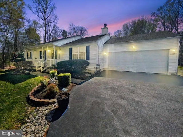 37217 Asher Rd, Mechanicsville, MD 20659 - ranch-style home with covered porch, an attached garage, a chimney, and driveway