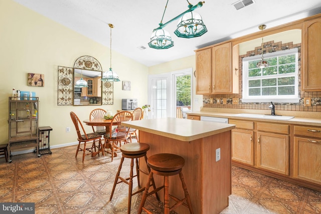 37217 Asher Rd, Mechanicsville, MD 20659 - kitchen with a kitchen island, visible vents, a sink, light countertops, and lofted ceiling
