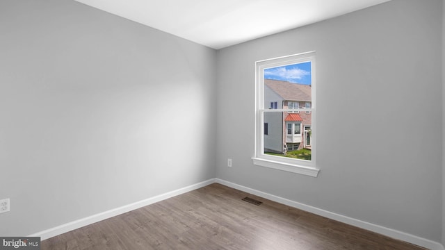 1315 Riverwood, Baltimore, MD 21226 - empty room with a healthy amount of sunlight, baseboards, wood finished floors, and visible vents