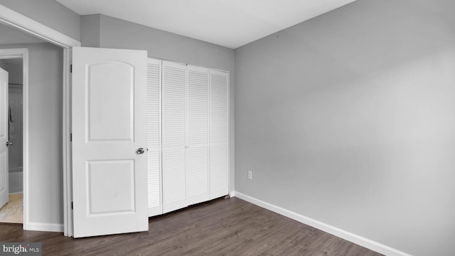 1315 Riverwood, Baltimore, MD 21226 - unfurnished bedroom featuring baseboards, a closet, and wood finished floors