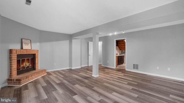 1315 Riverwood, Baltimore, MD 21226 - unfurnished living room with baseboards, visible vents, wood finished floors, and a fireplace