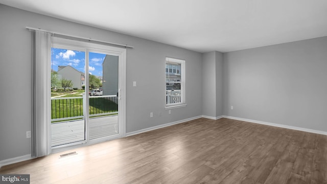 1315 Riverwood, Baltimore, MD 21226 - empty room with baseboards, wood finished floors, and visible vents