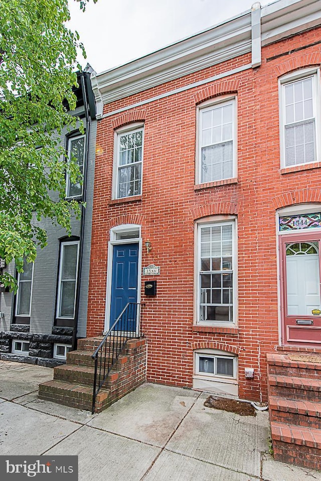view of property with brick siding and entry steps