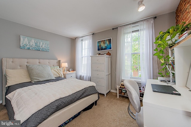bedroom with multiple windows and light colored carpet