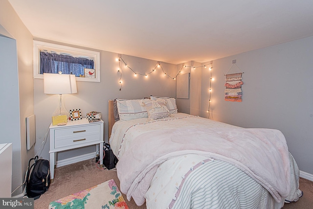 carpeted bedroom featuring baseboards