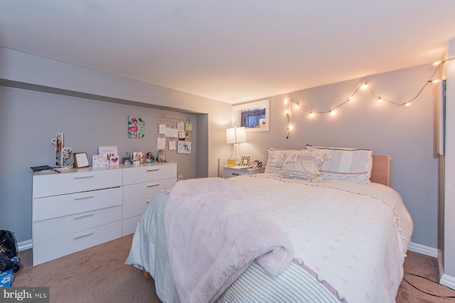 bedroom with baseboards and carpet floors