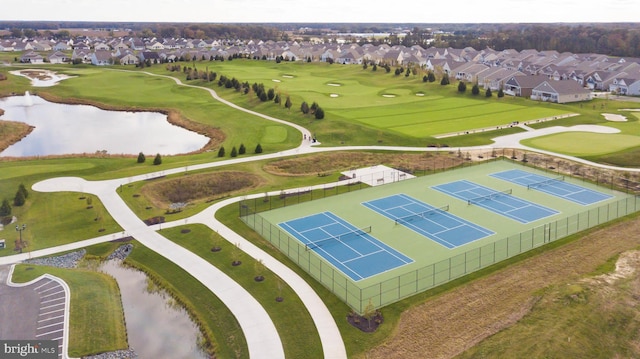 aerial view featuring golf course view, a residential view, and a water view