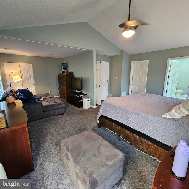 carpeted bedroom featuring ensuite bath, a ceiling fan, and vaulted ceiling