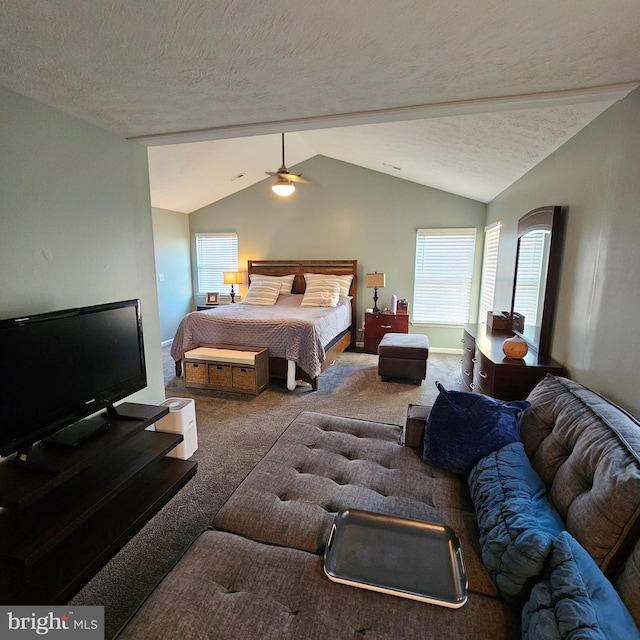 bedroom featuring a textured ceiling, multiple windows, carpet flooring, and lofted ceiling