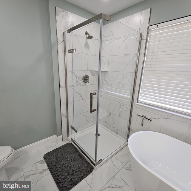 bathroom with baseboards, toilet, a soaking tub, marble finish floor, and a stall shower