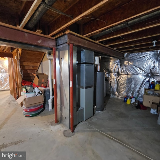 unfinished below grade area featuring heating unit and gas water heater