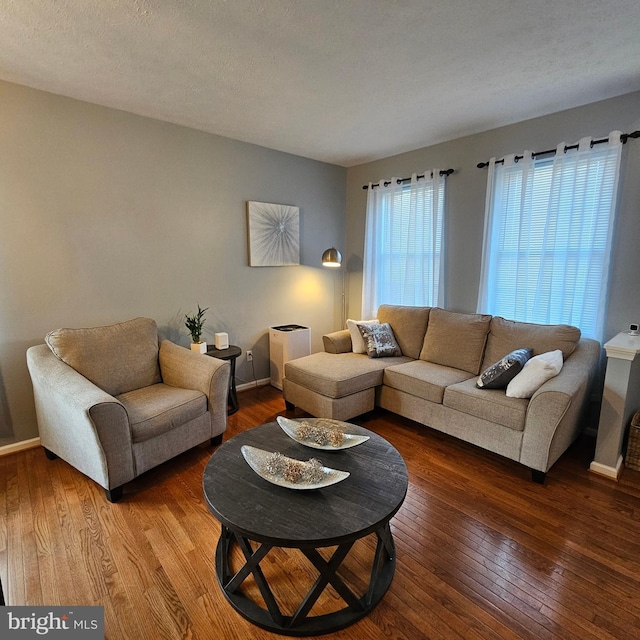 living room with baseboards and hardwood / wood-style floors