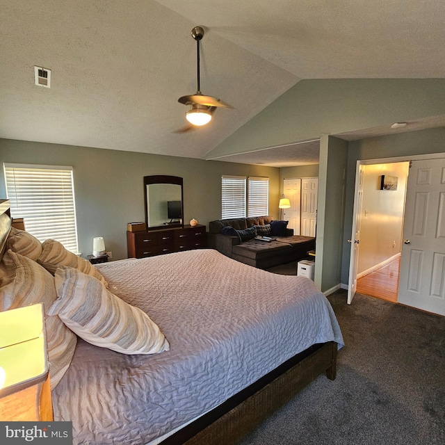 carpeted bedroom featuring a ceiling fan, baseboards, vaulted ceiling, and visible vents