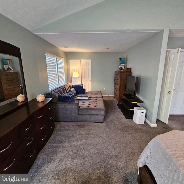 carpeted bedroom with baseboards and vaulted ceiling