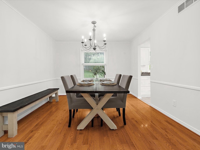 142 Tall Tree Trl, Arnold, MD 21012 - dining space with wood finished floors, visible vents, a chandelier, and ornamental molding