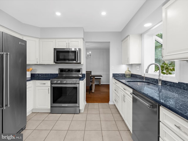 142 Tall Tree Trl, Arnold, MD 21012 - kitchen with white cabinets, a sink, dark stone counters, a chandelier, and appliances with stainless steel finishes