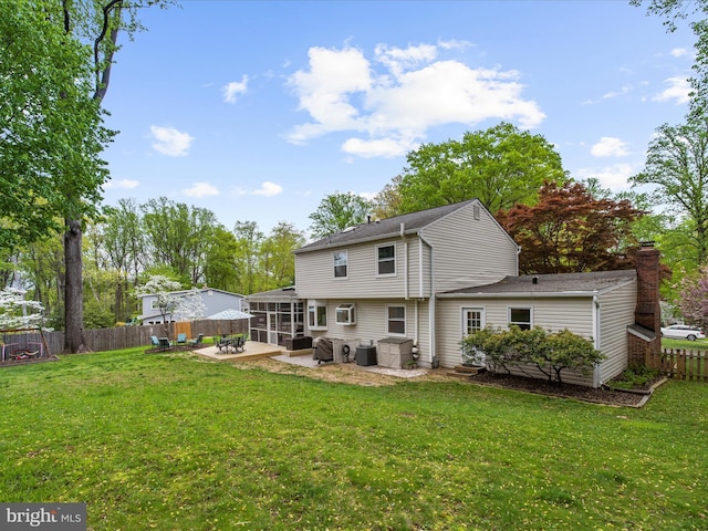 142 Tall Tree Trl, Arnold, MD 21012 - back of house featuring a yard, a sunroom, a patio, and fence
