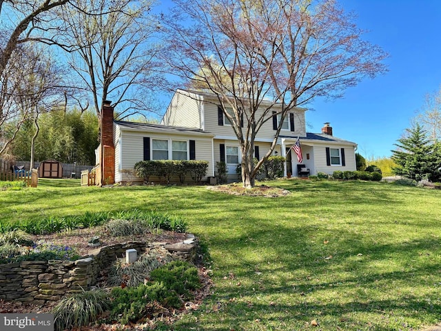 142 Tall Tree Trl, Arnold, MD 21012 - traditional home with a chimney, a front yard, an outbuilding, and a shed