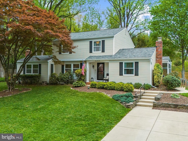 142 Tall Tree Trl, Arnold, MD 21012 - traditional home featuring a shingled roof, a front lawn, and a chimney