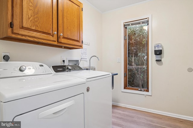 28 Beech Hill Dr, Newark, DE 19711 - washroom with separate washer and dryer, cabinet space, crown molding, and light wood-style flooring
