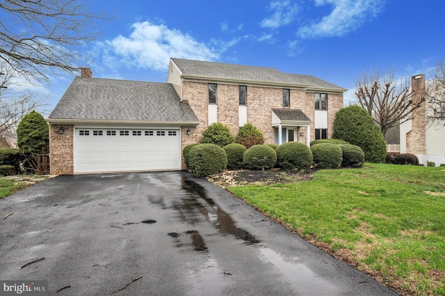 28 Beech Hill Dr, Newark, DE 19711 - colonial-style house with a chimney, driveway, an attached garage, a front yard, and brick siding