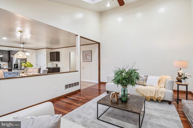 28 Beech Hill Dr, Newark, DE 19711 - living area with baseboards, wood finished floors, visible vents, and ceiling fan with notable chandelier