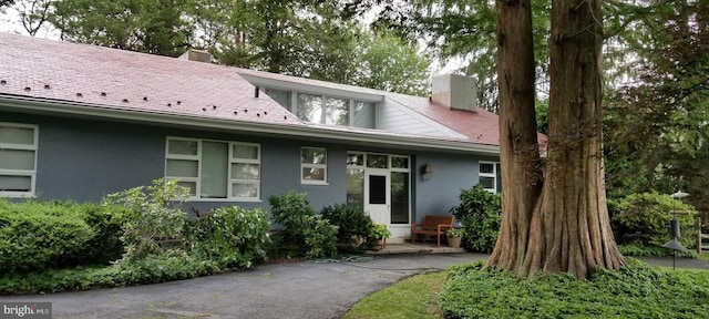 1426 Bryant Ln, Meadowbrook, PA 19046 - view of front of house with a chimney, stucco siding, and roof with shingles