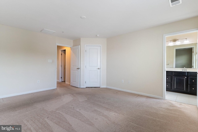 5542 Peanuts Ln, Waldorf, MD 20602 - unfurnished bedroom featuring light carpet, a sink, ensuite bath, baseboards, and visible vents