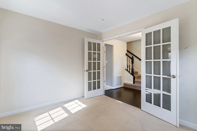 5542 Peanuts Ln, Waldorf, MD 20602 - carpeted spare room featuring french doors, baseboards, visible vents, and stairway