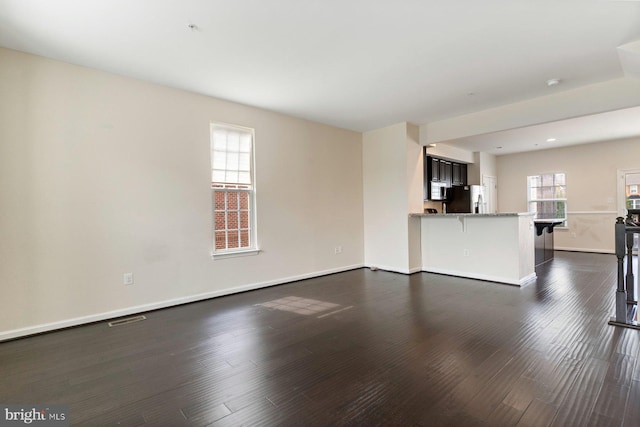 5542 Peanuts Ln, Waldorf, MD 20602 - unfurnished living room with baseboards, visible vents, and dark wood-type flooring