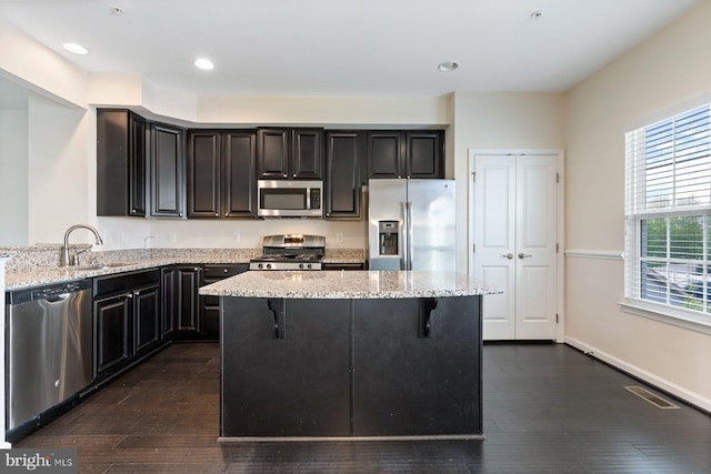 5542 Peanuts Ln, Waldorf, MD 20602 - kitchen featuring visible vents, a kitchen bar, light stone counters, a sink, and stainless steel appliances