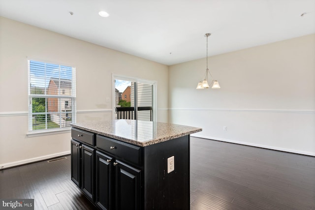 5542 Peanuts Ln, Waldorf, MD 20602 - kitchen with light stone countertops, baseboards, a center island, dark cabinetry, and decorative light fixtures