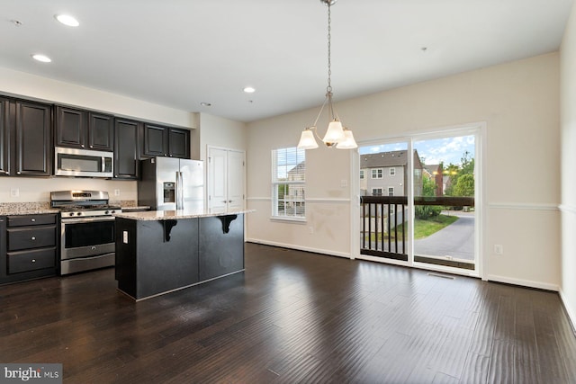 5542 Peanuts Ln, Waldorf, MD 20602 - kitchen with light stone countertops, baseboards, a kitchen bar, recessed lighting, and appliances with stainless steel finishes
