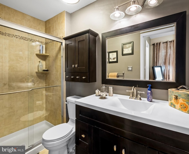 full bath with toilet, a stall shower, and vanity