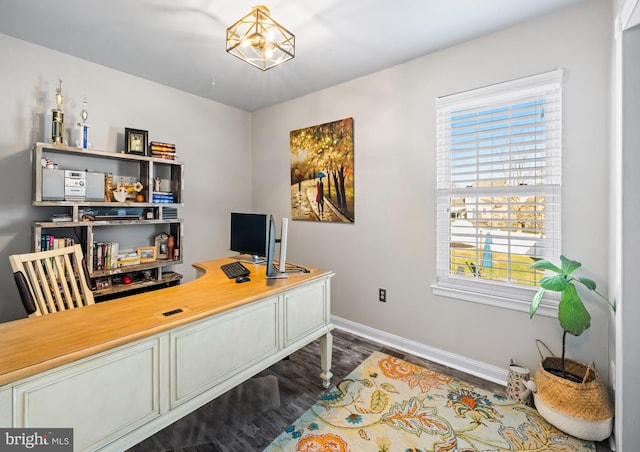 office space with baseboards and dark wood finished floors
