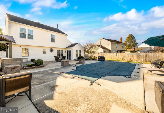 view of swimming pool featuring a fenced in pool, a patio area, and fence