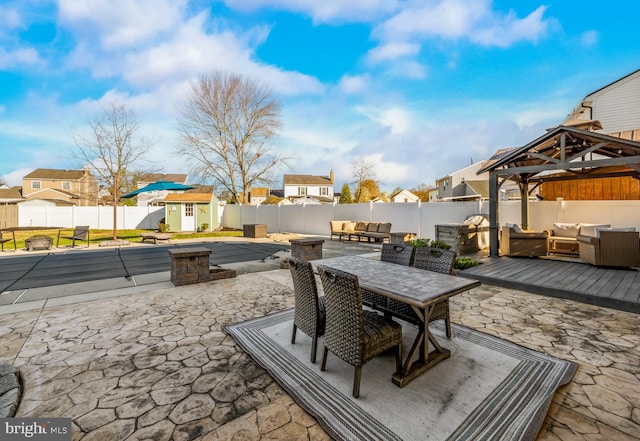 view of patio / terrace with a shed, outdoor lounge area, a gazebo, a fenced backyard, and an outdoor structure