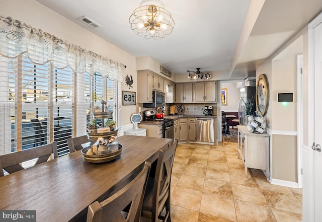 dining area with visible vents and a chandelier