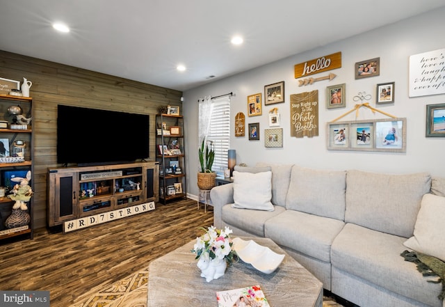 living area with recessed lighting, wooden walls, and wood finished floors