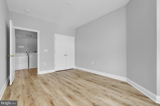 503 King Farm Blvd Unit 306, Rockville, MD 20850 - unfurnished bedroom featuring separate washer and dryer, light wood-type flooring, a closet, and baseboards
