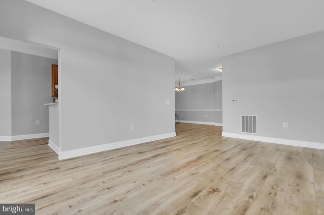 503 King Farm Blvd Unit 306, Rockville, MD 20850 - spare room with light wood-type flooring, baseboards, a chandelier, and crown molding